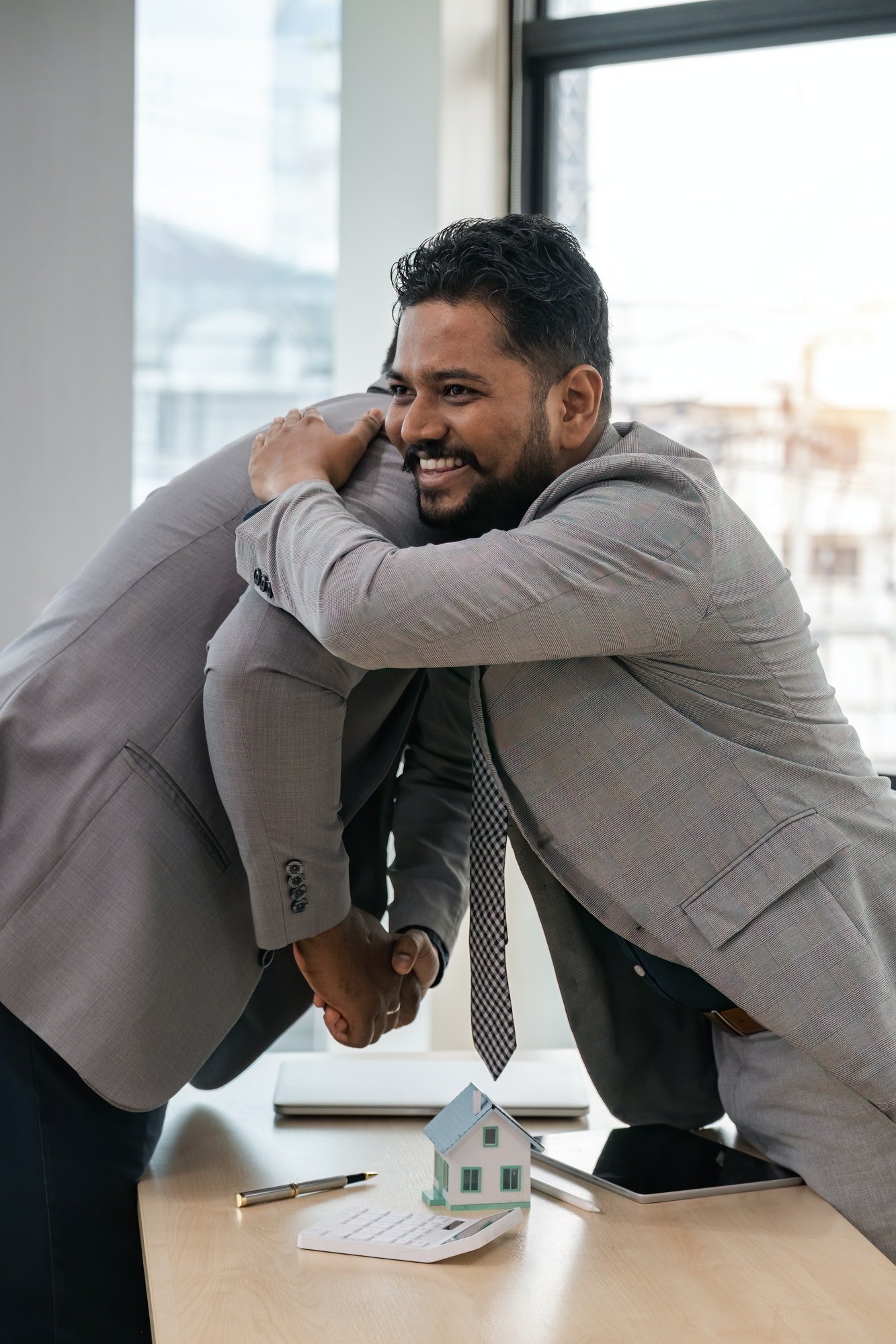 Real estate agent African American handshake to customer indian to congratulate after signing a